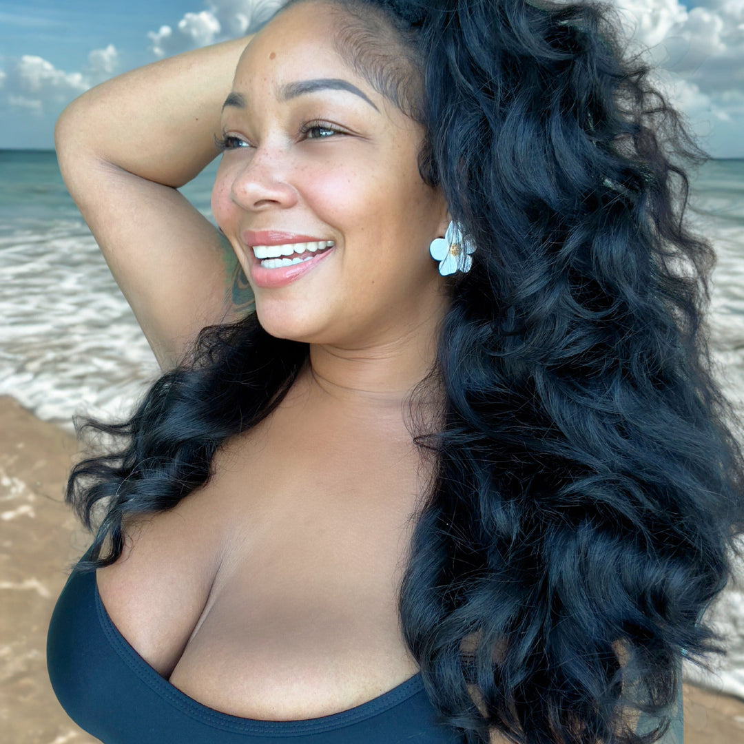 Woman with long, wavy hair on a beach